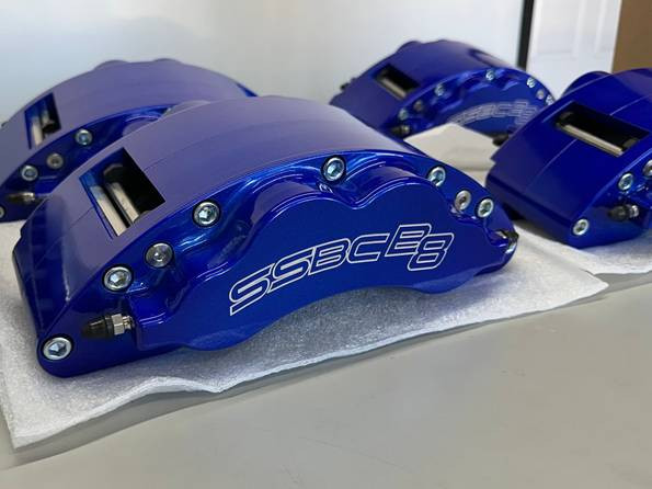 Set of blue SSBC B8 Barbarian calipers resting on foam packing