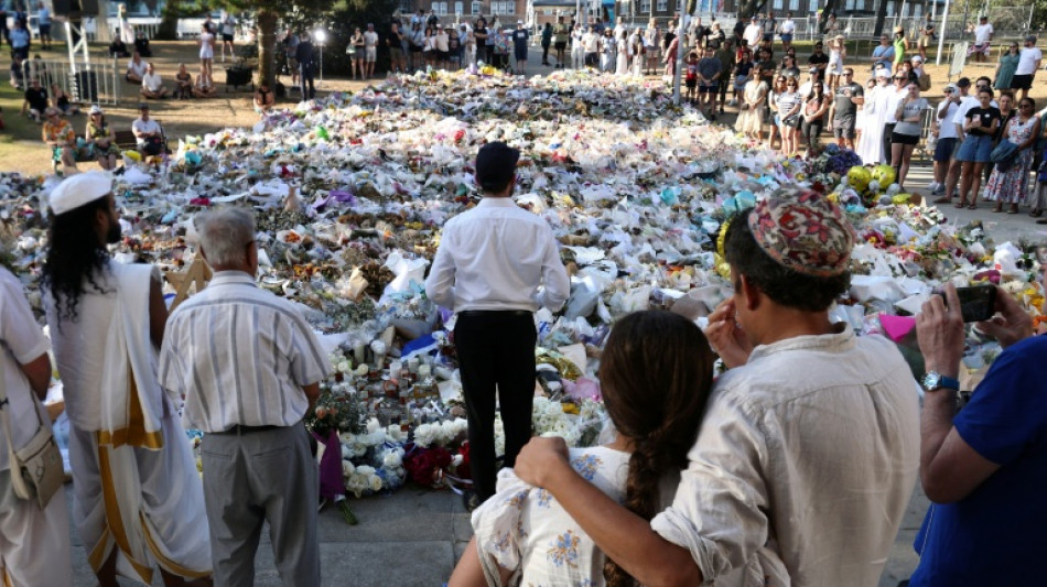 Australia falls silent, lights candles for Bondi Beach shooting victims