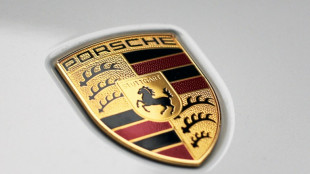 Porsche slows electric shift, prompting VW profit warning
